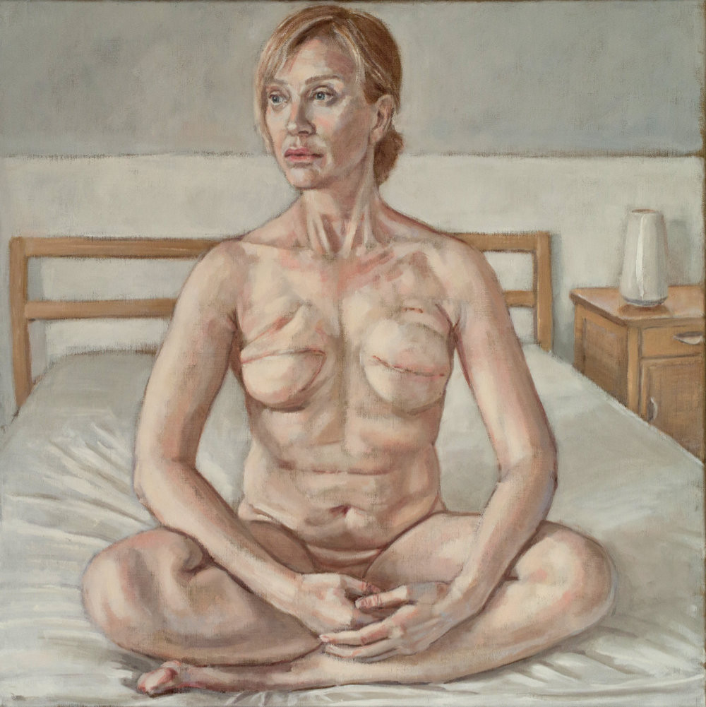 portrait of woman with mastectomy sitting on bed