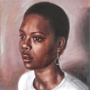 portrait of woman wearing gold earrings