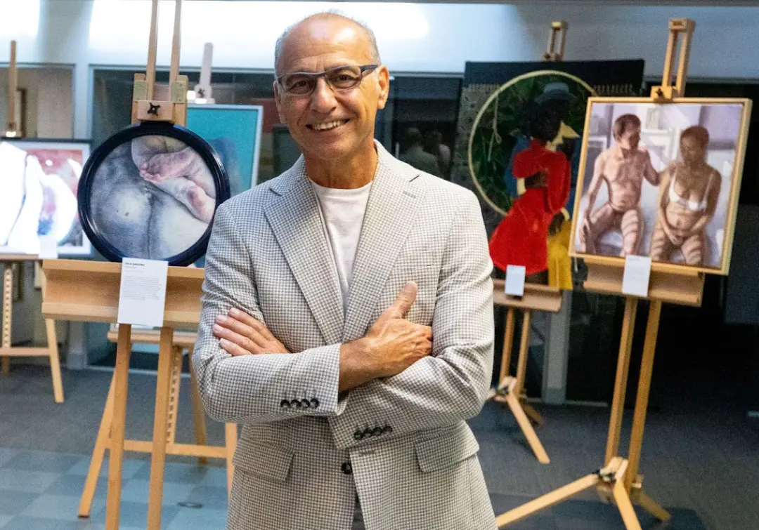 theo paphitis standing next to the painting Man and Woman