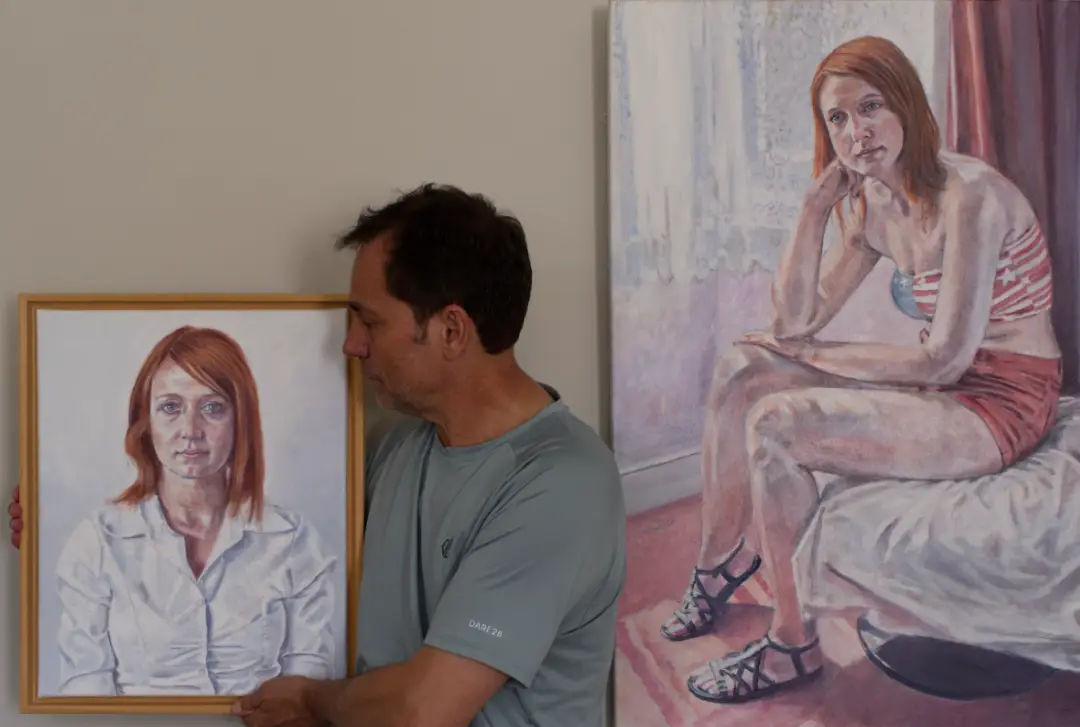artist showing two different size portrait sizes - a head and shoulders portrait painting and a full body portrait
